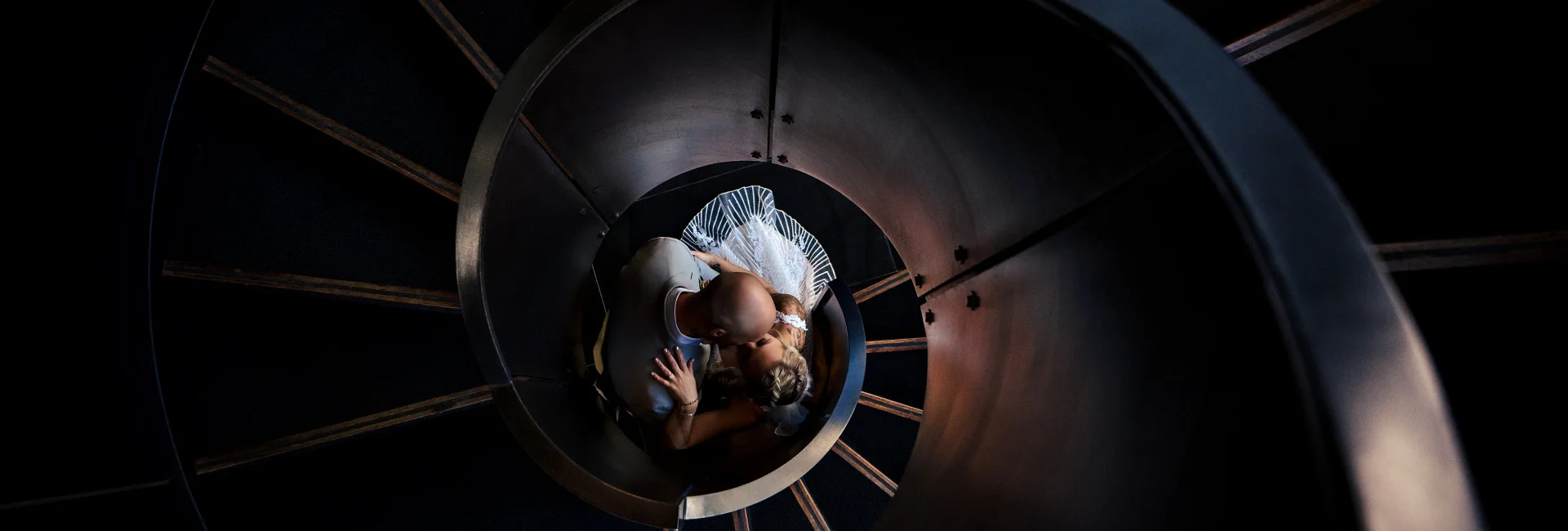 Bride and groom kiss at the staircase in Calgary downtown