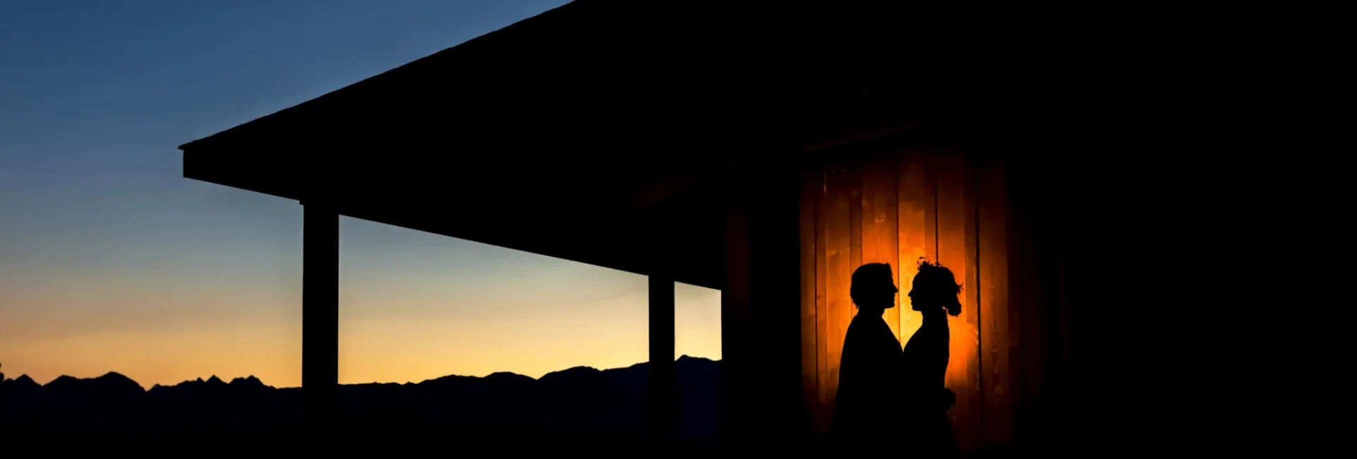Silhouette portrait of bride and groom during sunset