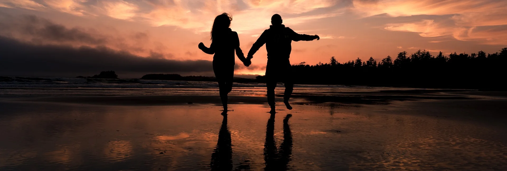 Couple in love is running on the beach in Banff National Park