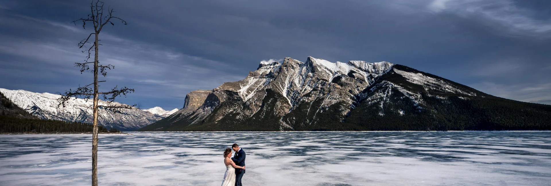 Newlyweds hug during after wedding session in Banff