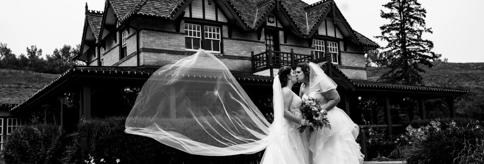 Same sex coupe kissing during their Calgary Wedding