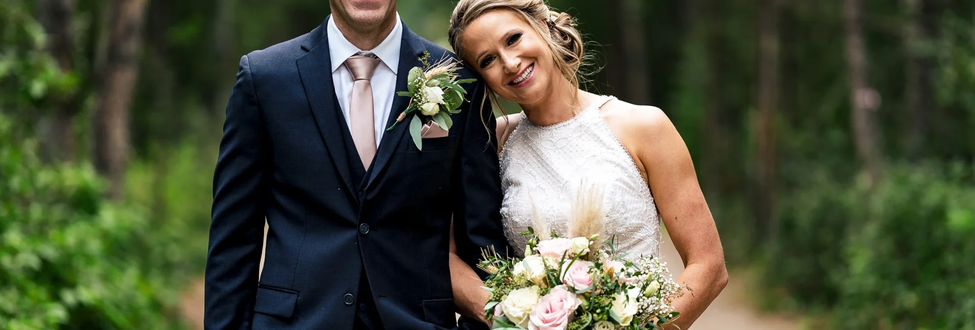 Bride's and Groom's Portrait. They are looking at the camera's of Calgary Wedding Photographer
