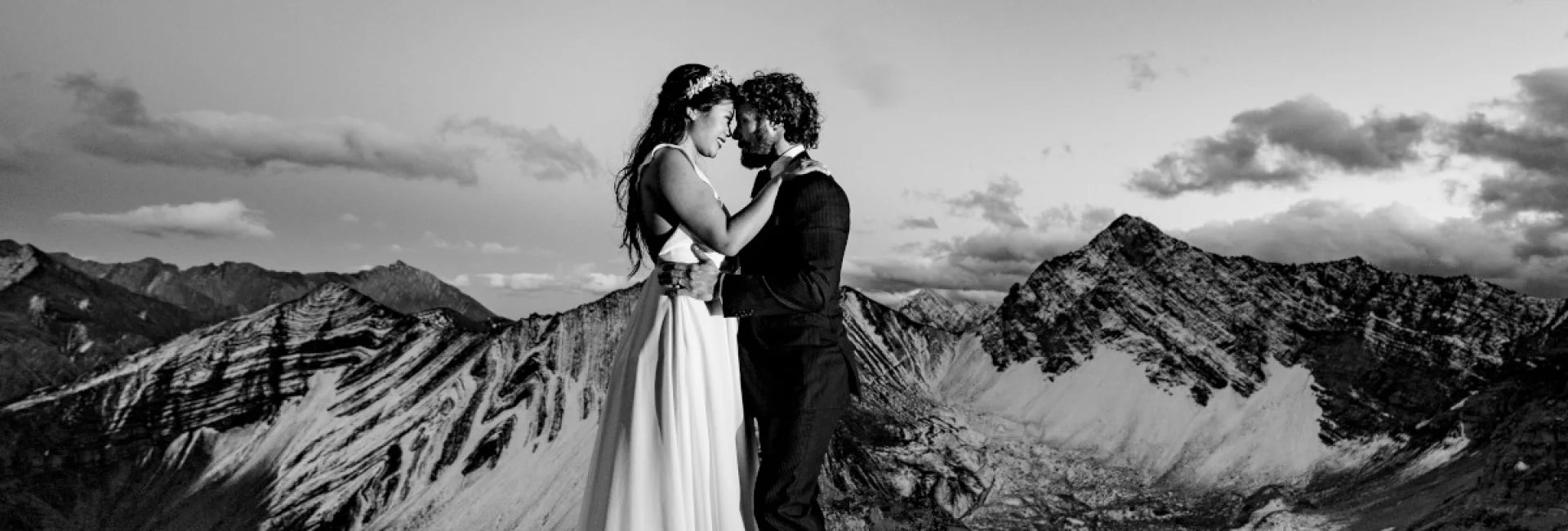 Bride and Groom touches their foreheads and look into eyes during Mountain Adventure Photo Session in Banff National Park.