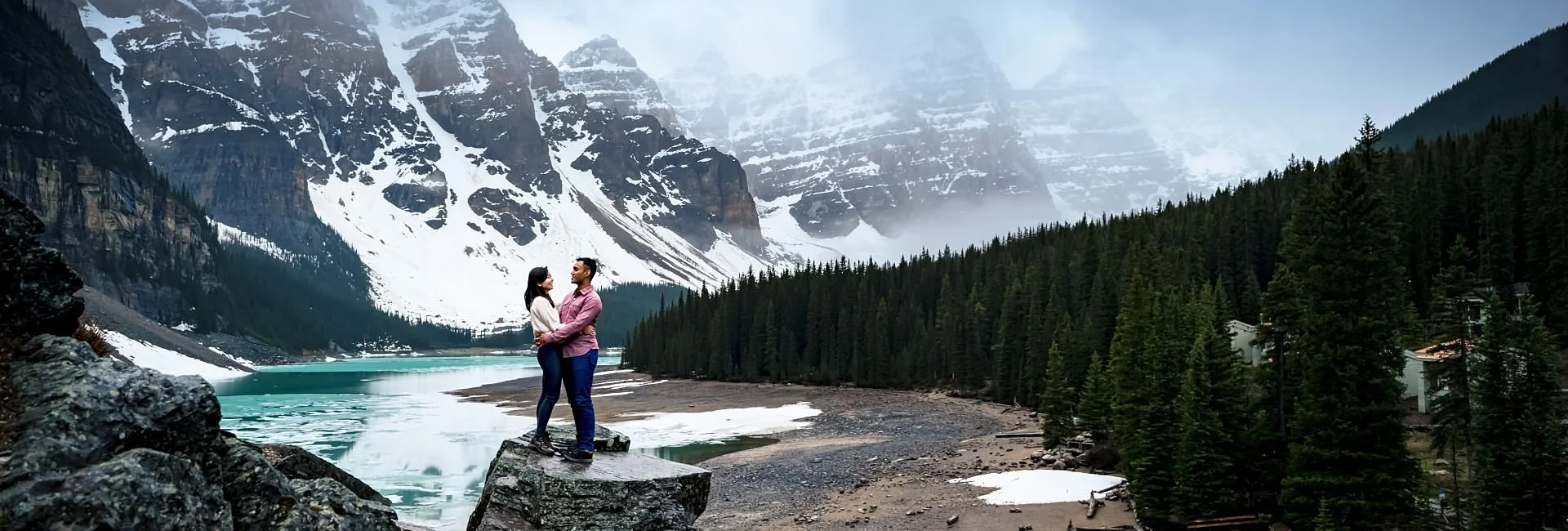 Moraine Engagement Session. Couple in love stands at the rock and look at each other.