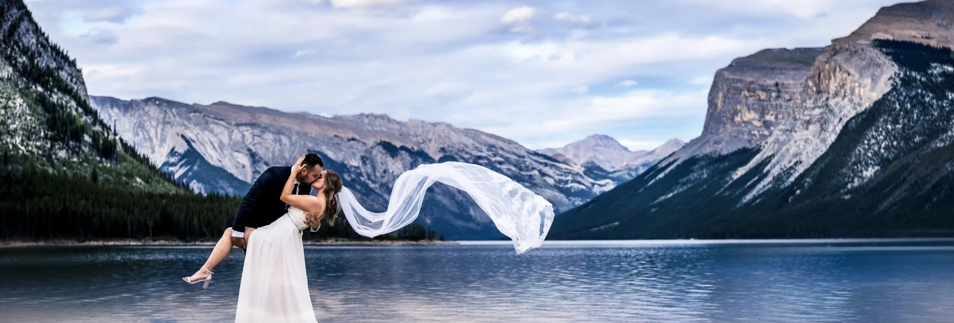 Married couple dance at Minnewanka Lake