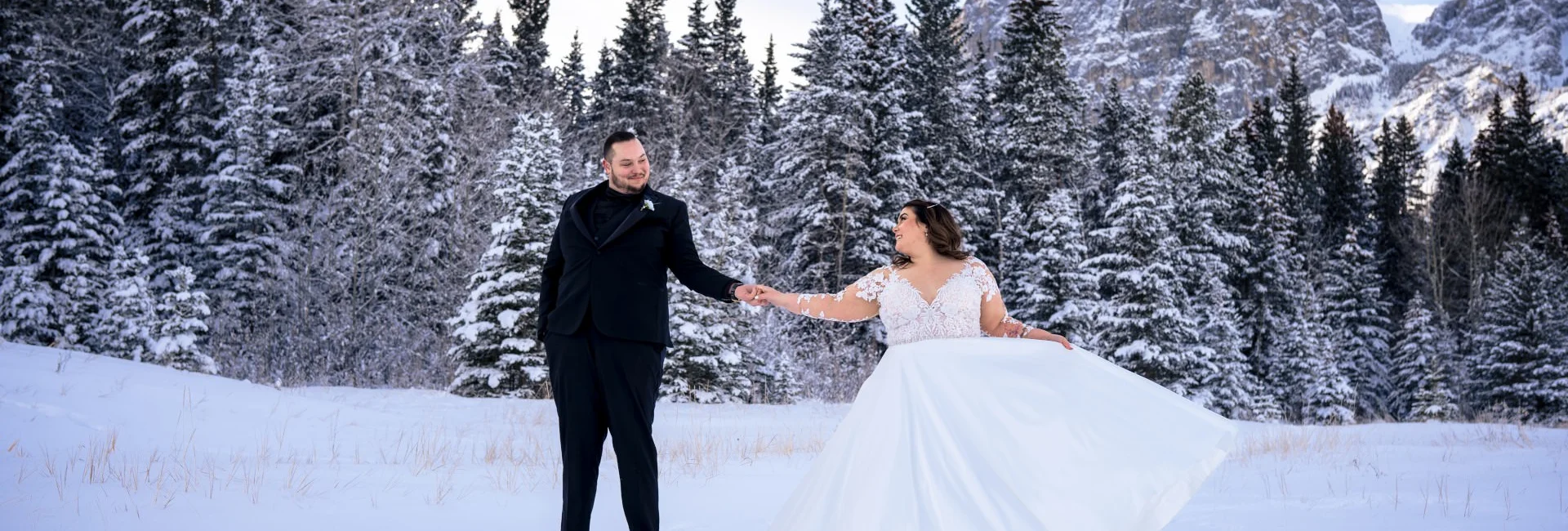 Newlyweds dance during winter time in Banff.