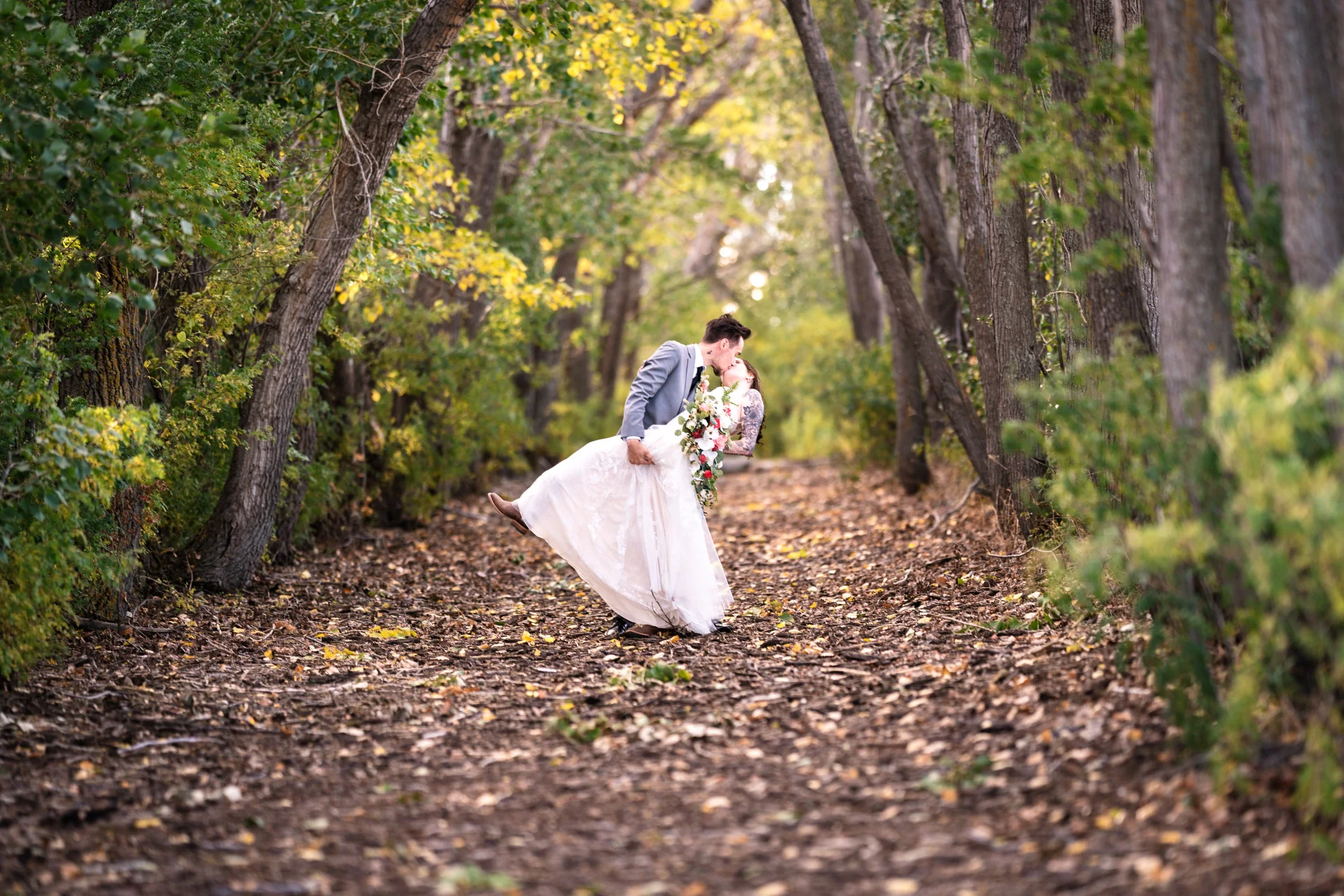 Cagary Wedding Photographer captured a newlyweds sharing a kiss in the forest