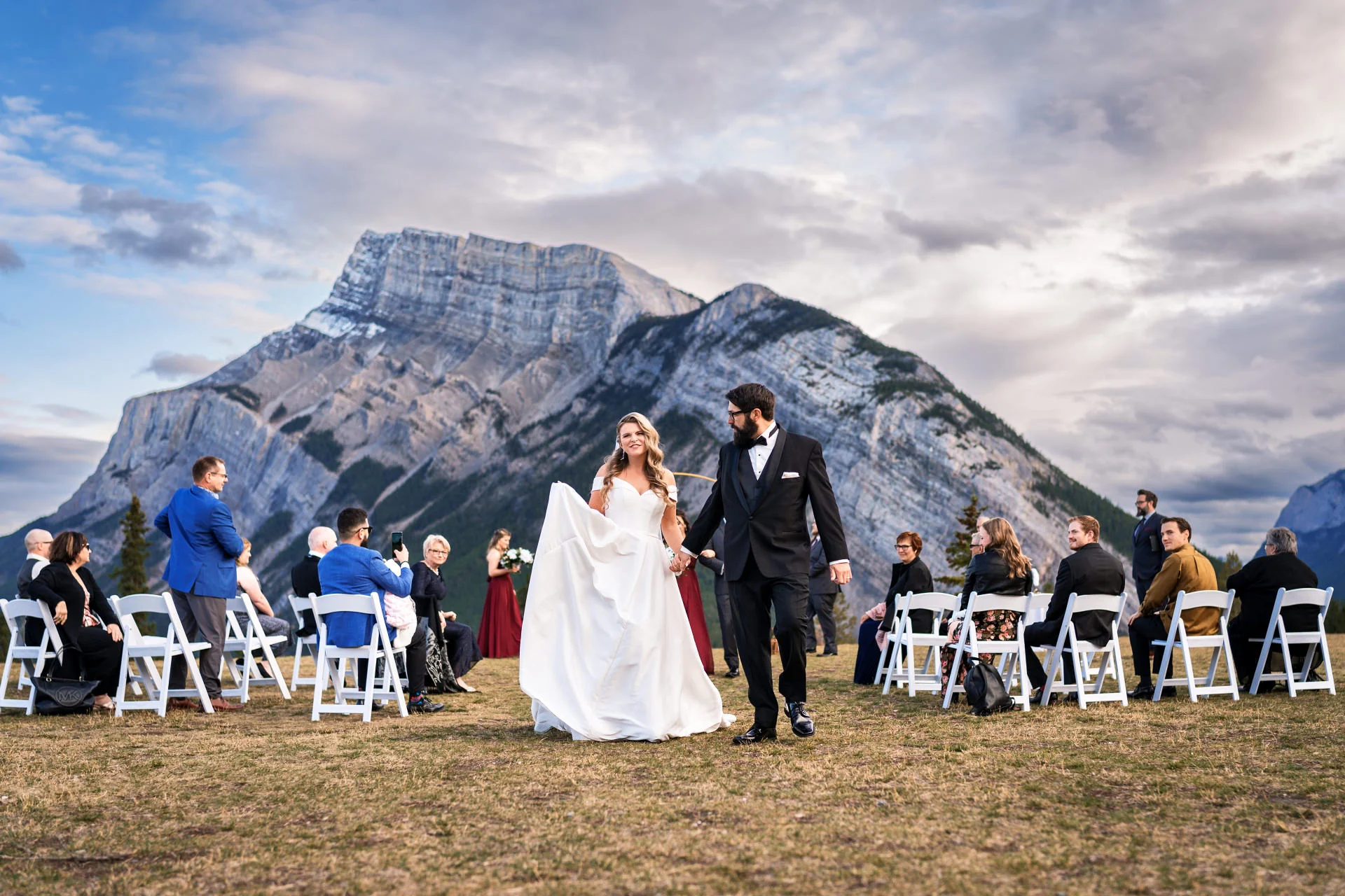 Bride and groom walkin down the aisle in Banff