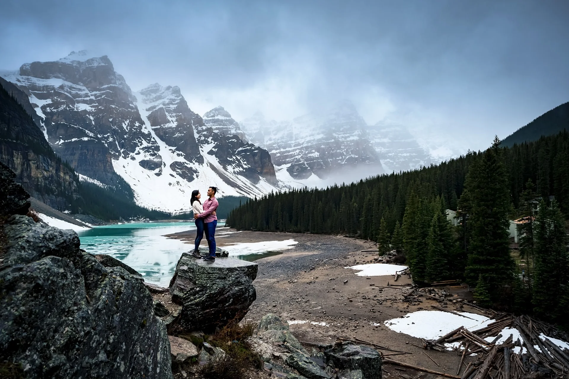 Moraine Engagement Session. Couple in love stands at the rock and look at each other.