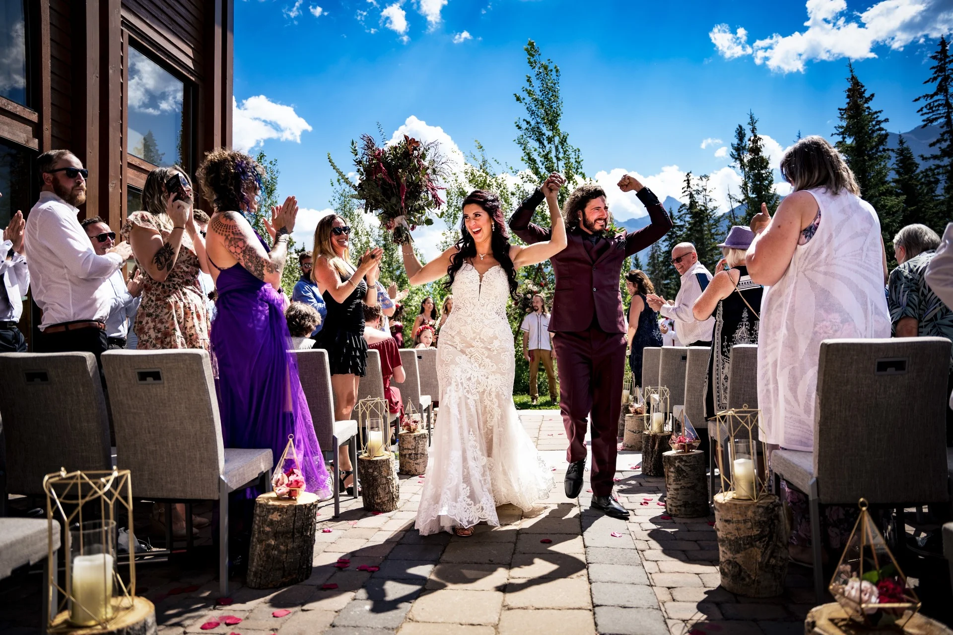 Happy walk of married couple with hands up after Banff Wedding Ceremony
