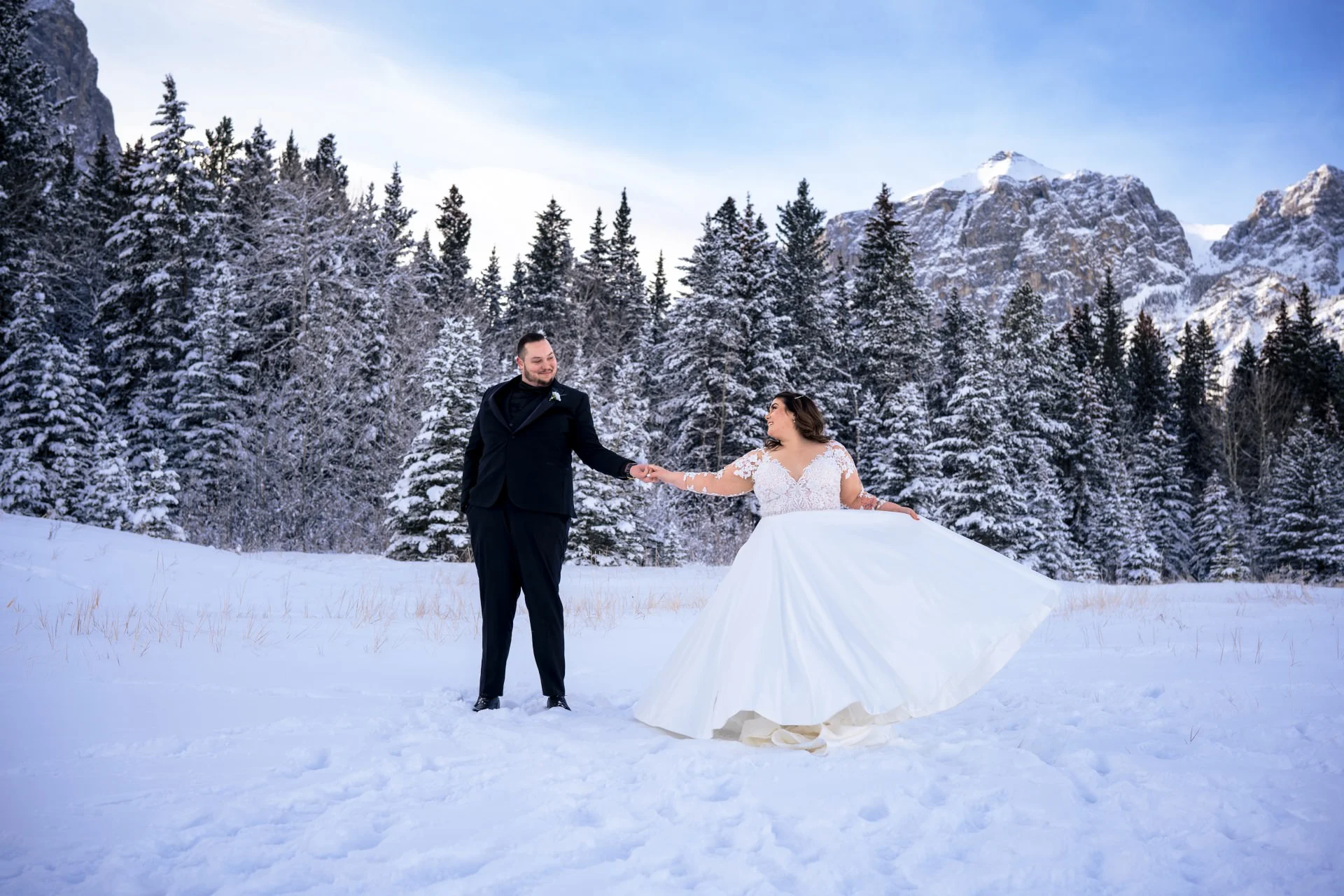 Newlyweds dance during winter time in Banff.
