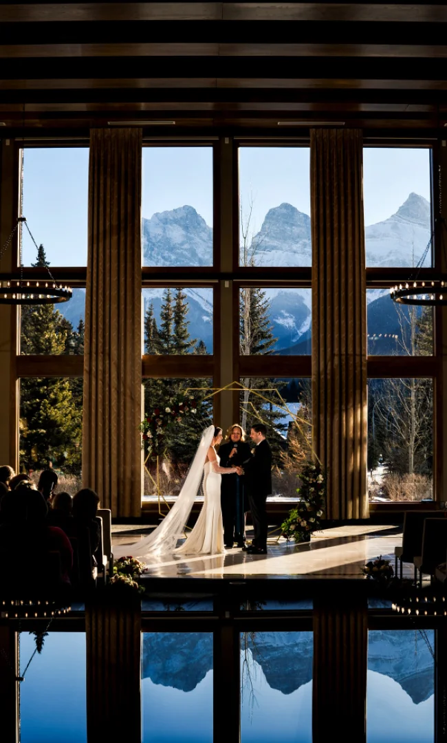 Bride and groom exhcange the vows during wedding ceremony in Canmore