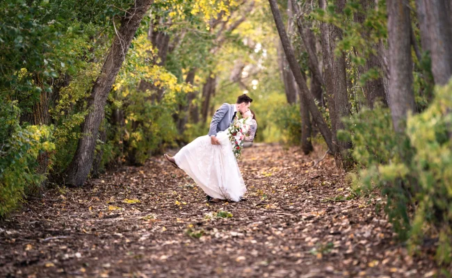 Cagary Wedding Photographer captured a newlyweds sharing a kiss in the forest