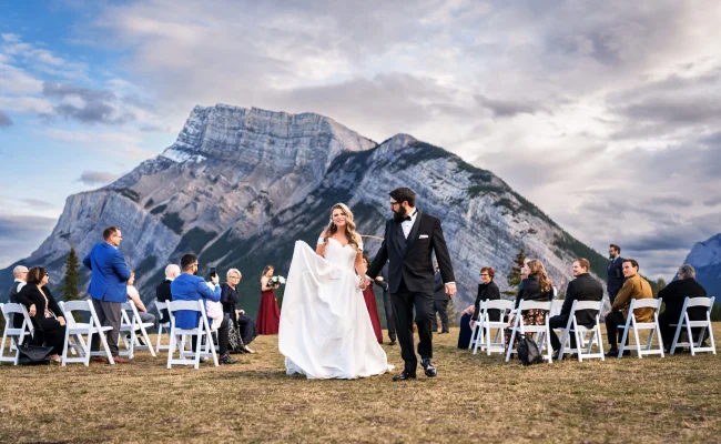 Bride and groom walkin down the aisle in Banff