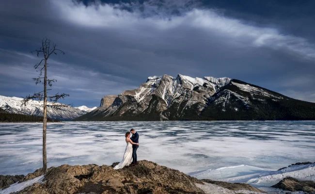 Newlyweds hug during after wedding session in Banff