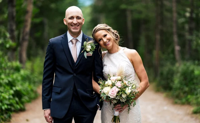 Bride's and Groom's Portrait. They are looking at the camera's of Calgary Wedding Photographer