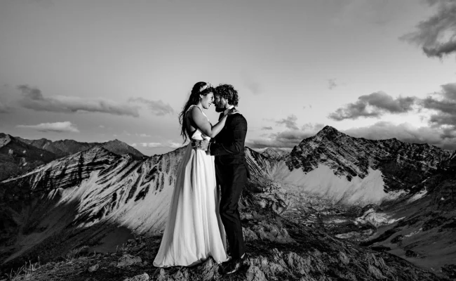 Bride and Groom touches their foreheads and look into eyes during Mountain Adventure Photo Session in Banff National Park.