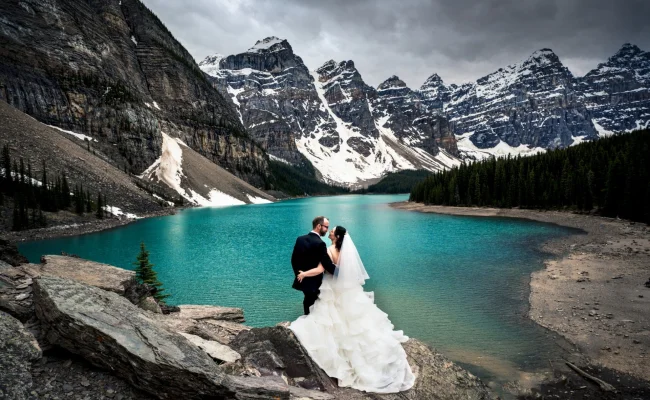 Married couple adore unique view of Moraine Lake and Canadian Mountains