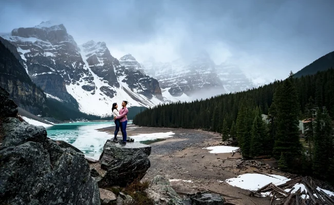 Moraine Engagement Session. Couple in love stands at the rock and look at each other.