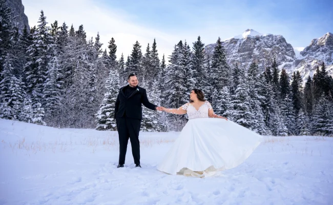 Newlyweds dance during winter time in Banff.