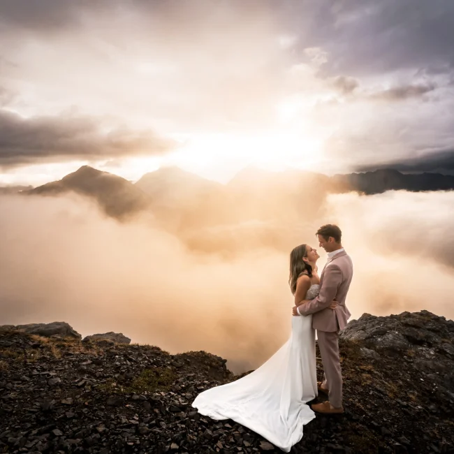 Wedding couple embracing in front of breathtaking Banff scenery, capturing their special day in the majestic Canadian Rocky Mountains during stunning sunset.