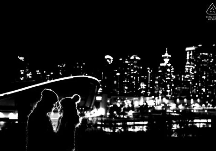 backlighted couple in love against stunning city of Calgary