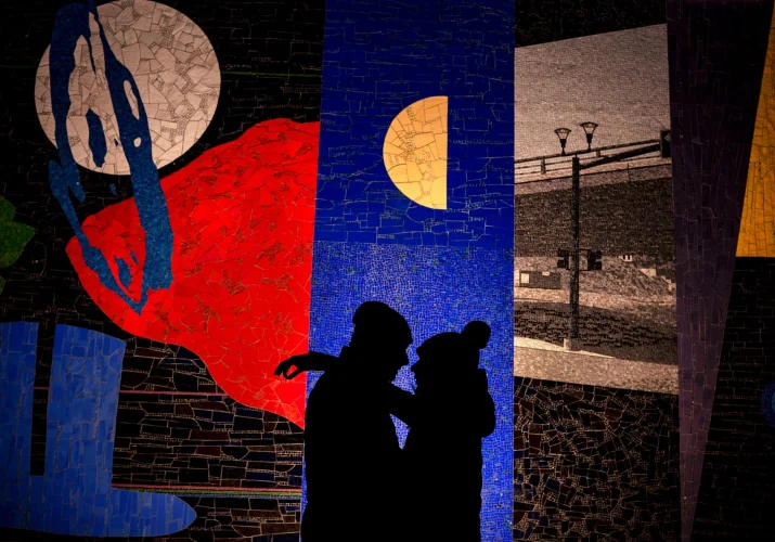 Incredible creative photograph of silhouette couple in love against mosaic wall in Calgary.