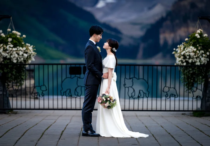 Bride and groom in a hug, facing each other at the majestic location Lake Louise I Banff. Intimate moment captured by Banff Wedding Photographer.