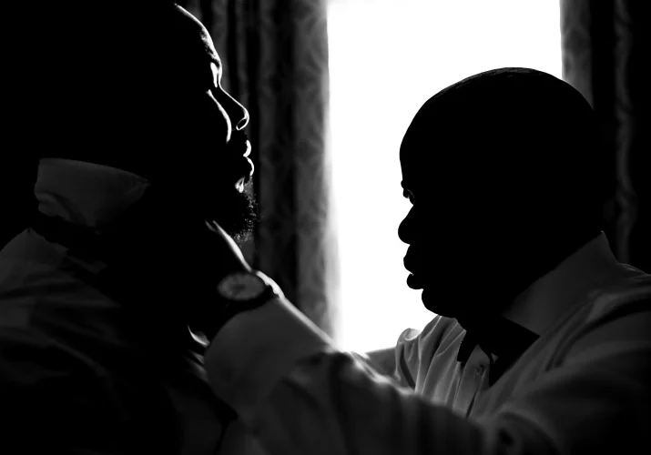 Best men fix the grooms tie.
