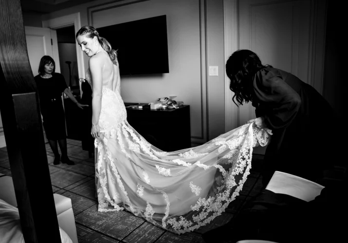 Banff Wedding Photography in black and white of the bride and her sister fixing the wedding dress.