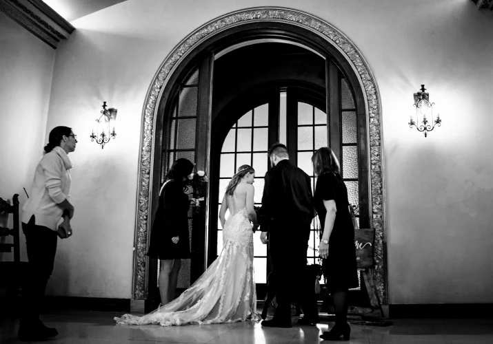 Bride and her family in front of huge door about to enter the Banff Wedding Ceremony at Fairmont Hotel.