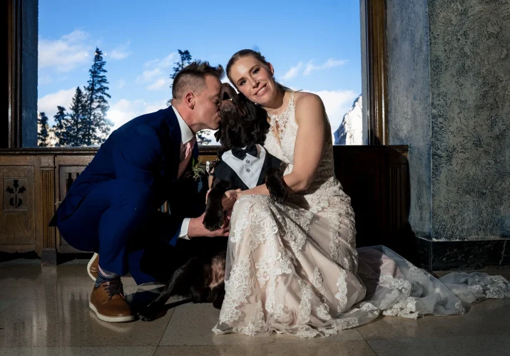 Bride and groom's portrait with their fur baby.