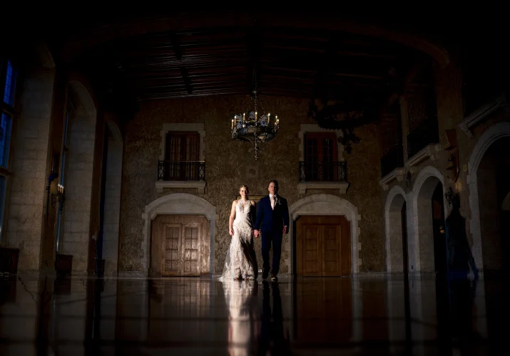 Bride and groom walk holding their hands at the ball room. Banfff Wedding Photography.