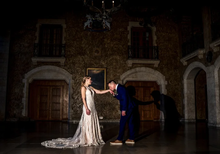 Groom kisses the bride's hand.