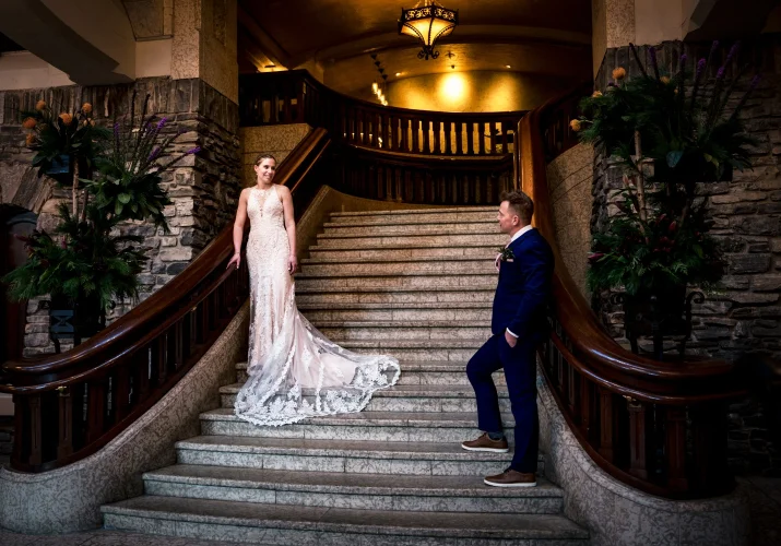 Newlyweds and the stairs looking at each other..