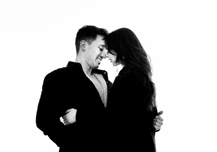 Black and white photograph of couple in love in intimate moment when they are about to kiss.