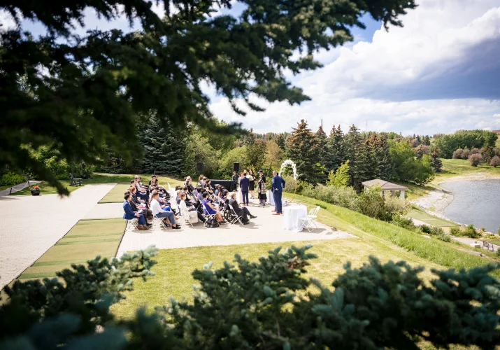 Outdoor Wedding Ceremony in Calgary captured through the tree branches