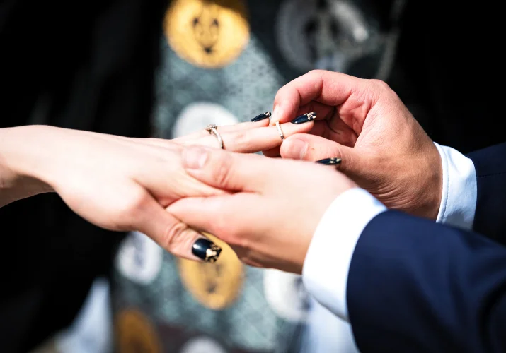 Bride's and Groom's hands on the Calgary Wedding Ceremony when the groom puts the wedding ring on the bride's hand.