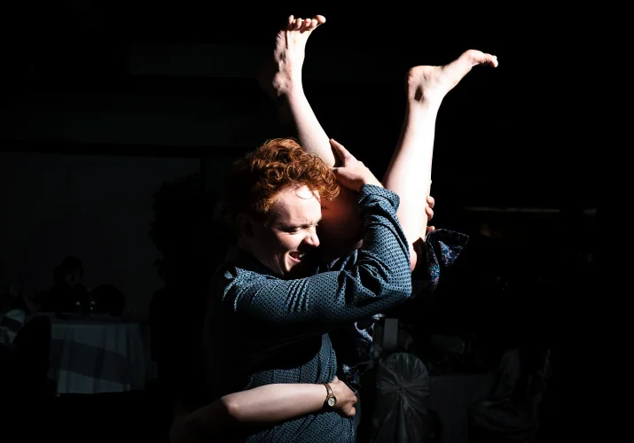 Man lifts his wife up. Her legs on the his head level. Crazy dance floor at the Calgary Wedding.