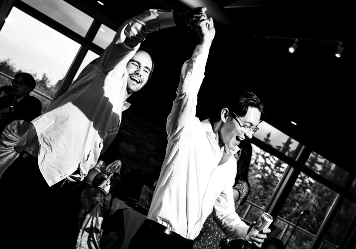 Two man dance together at the Calgary Wedding.
