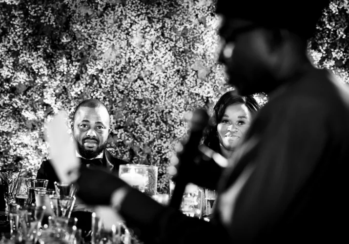 Father of the bride gives a speech on the traditional Nigerian wedding in Calgary. Fantastic shoot through the microphone and the paper on the bride and groom.