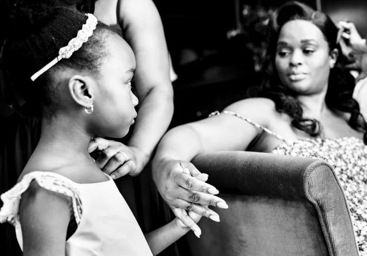 Photograph in black and white of the bride and her daughter during getting ready time before the wedding ceremony.