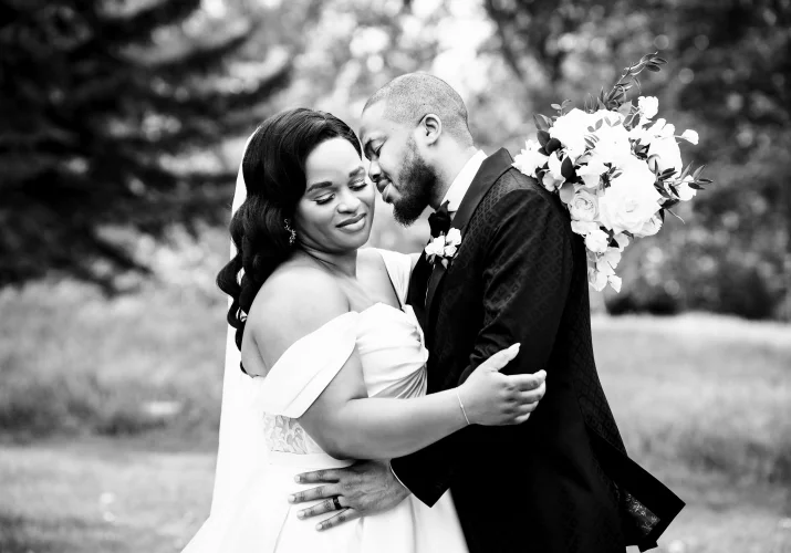 The groom try to kiss his wife on the neck. Romantic moment between the couple during portrait wedding session in Calgary.