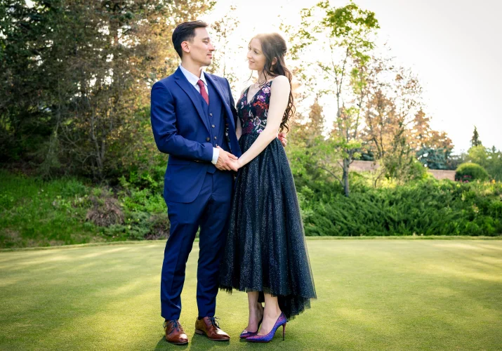 Newlyweds portrait while they holds hands and look at each other.