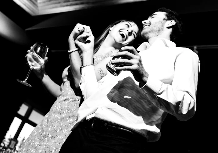 Couple holds their hands and laugh