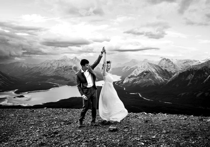 Newlyweds dance in the mountains. Moment captured by Banff Wedding Photographer.