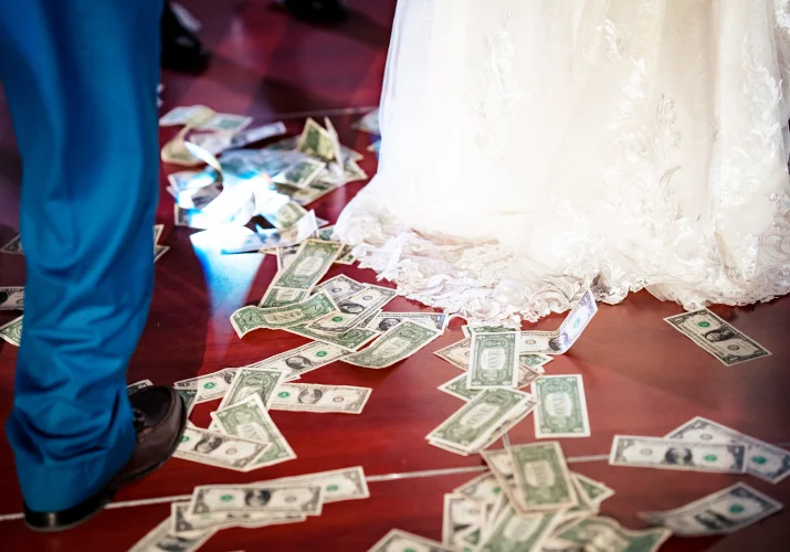 Money on the floor during money spraying at Nigerian wedding in Calgary.