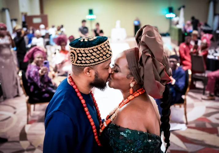 First kiss on the bride and groom dressed in a Nigerian attire.