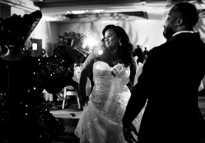 money spraying of the newlyweds at Nigerian wedding captured by Calgary Wedding Photographer.
