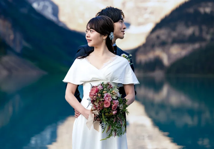 Bride and groom's portrait while looking on different direction. Creative photograph taken by Banff Wedding Photographer.